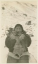 Image of Ah-l-na-gee-to (Arnakittoq) eating meat